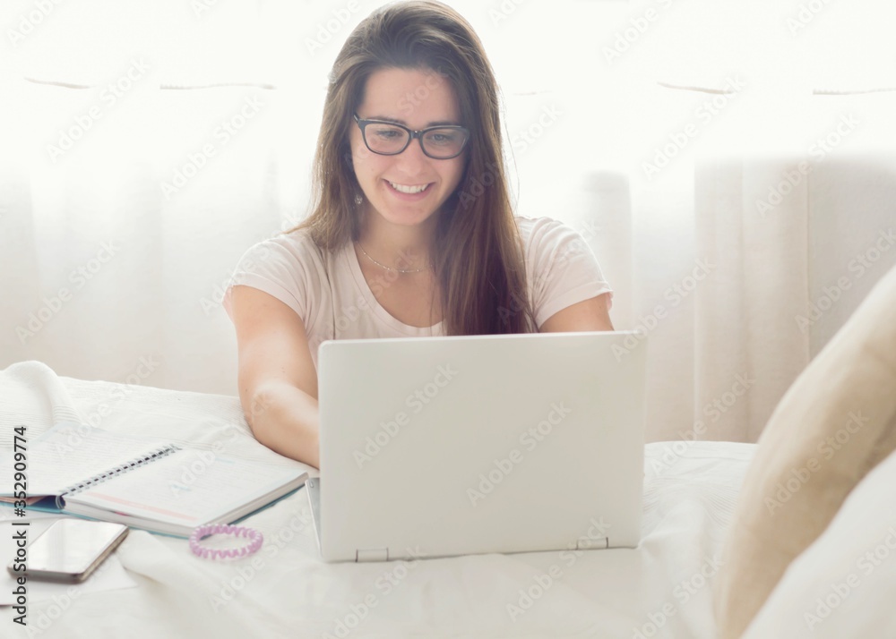 Teenage boy working from home with his laptop Teenage boy working from home with his laptop