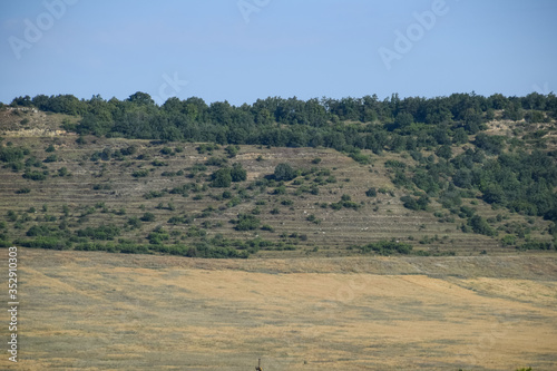 Landscapes of Crimean nature. Fields and hills visible from the car window from the road.