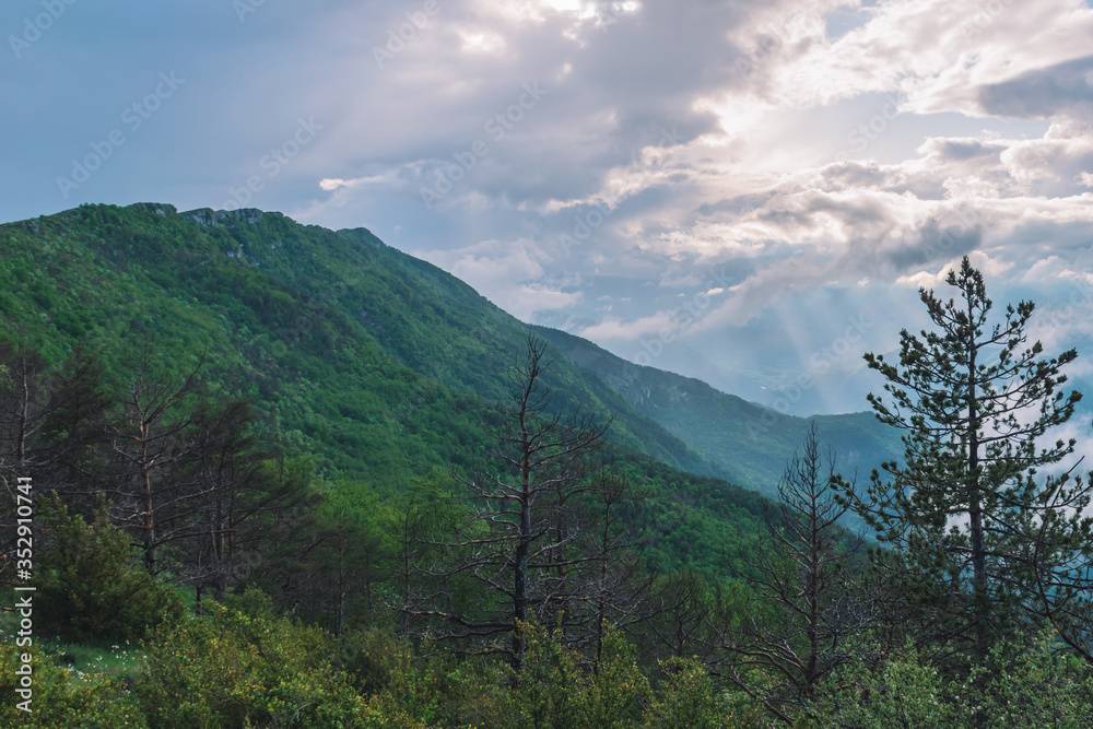 A picturesque wide landscape view of the French Alps mountains covered in clouds in the evening (Col de Rigaudon, Alpes-Maritimes, France) A picturesque wide landscape view of the French Alps mountains covered in clouds in the evening (Col de Rigaudon, Alpes-Maritimes, France)
