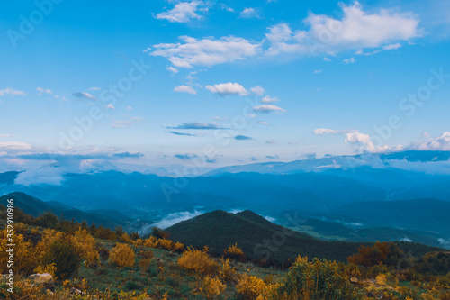 A picturesque wide landscape view of the French Alps mountains covered in clouds in the evening  Col de Rigaudon  Alpes-Maritimes  France 