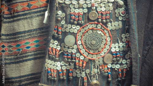 A close up of beads and button on cloth