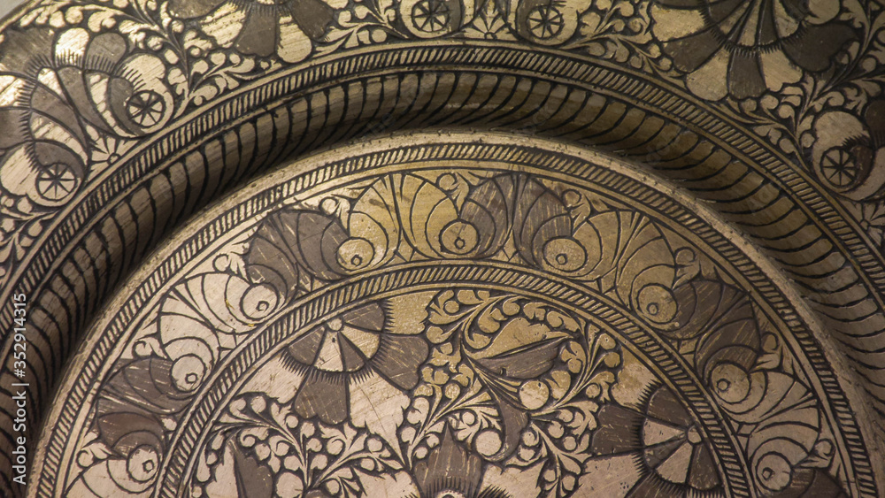 A close up of engraved pattern on a metal