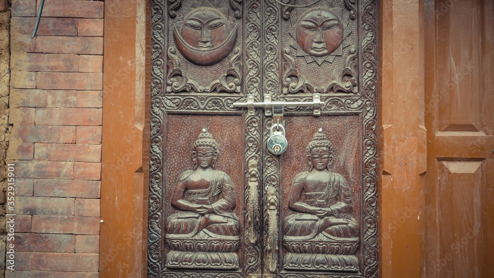 A door with engraved or faces and person