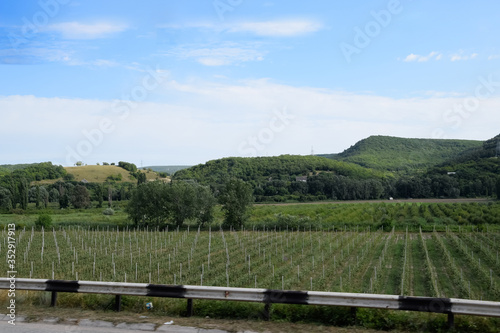 Landscapes of Crimean nature. Fields and hills visible from the car window from the road.