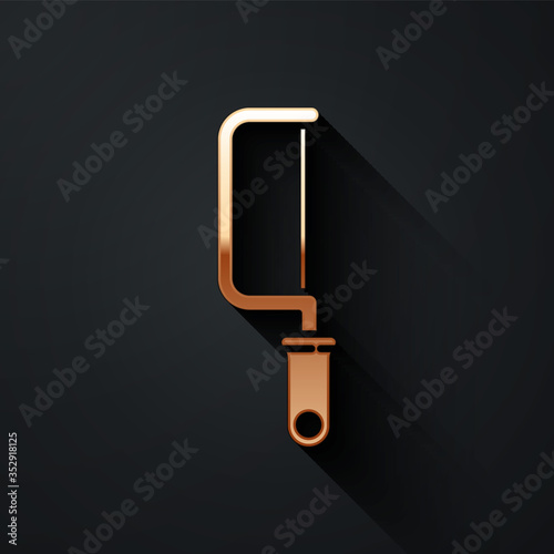 Gold Hacksaw icon isolated on black background. Metal saw for wood and metal. Long shadow style. Vector.