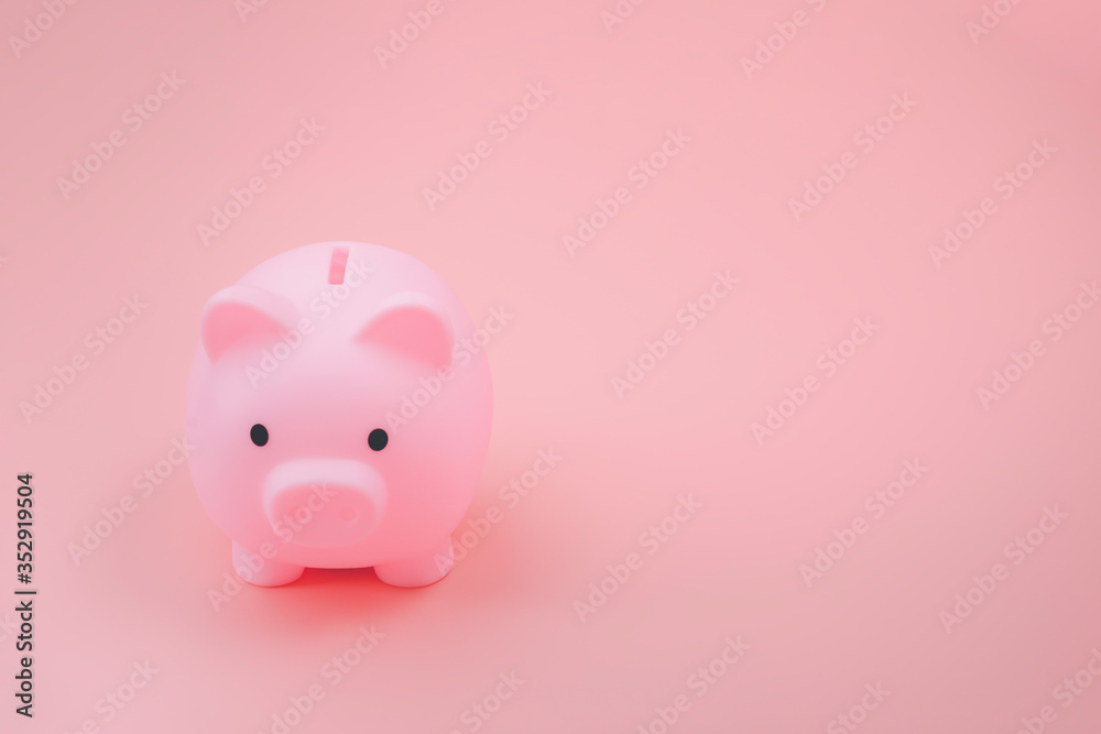 Pink piggy bank facing the camera on old rose color background with copy space. The concept of financial, money saving and future planning.
