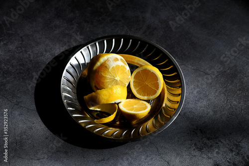 sliced lemons in a metal plate on the table