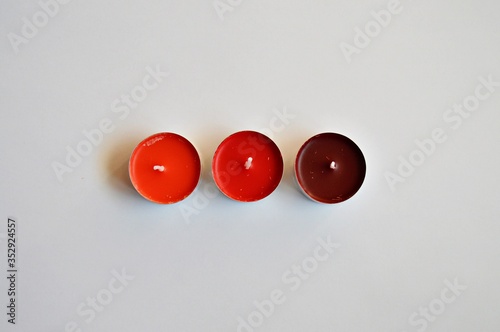 Three red candles on a white background