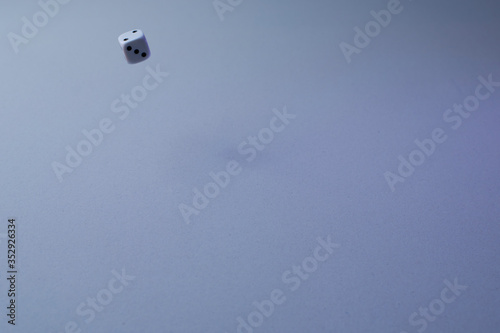 A dice on white background flying,