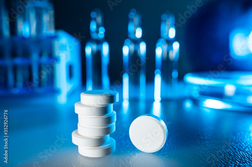 Medication pills lie on a table in a modern laboratory