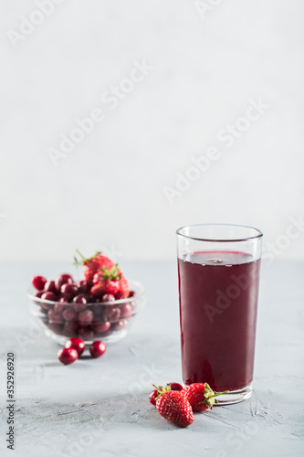 The concept of a summer refreshing drink made from red berries: berry Morse made from fresh strawberries and cranberries