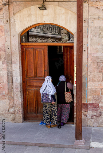 Women entering a mosque in Turkey photo