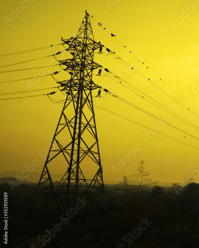 Electric tower with yellow background.