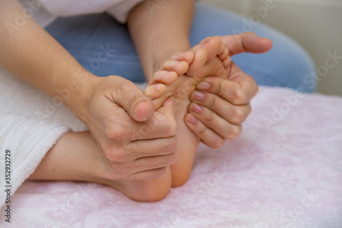 Close-up of children's foot massage on the sofa. © Мария Бадаева