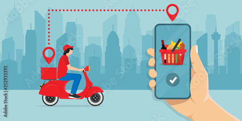 Food delivery application on the smartphone screen. Tracking the delivery man on a moped with ready-made food. Logistics concept, city skyline in the background.