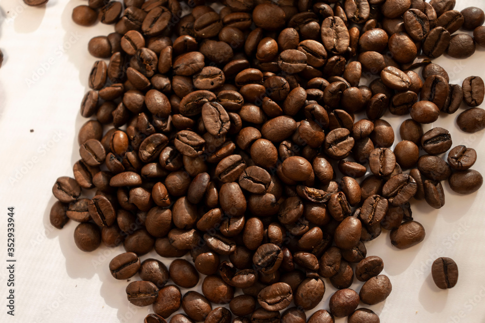 coffee beans a lot of coffee scattered on a white background coffee beans a lot of coffee scattered on a white background