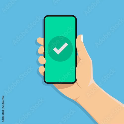 Checkmark on smartphone screen.hand holds a mobile phone.