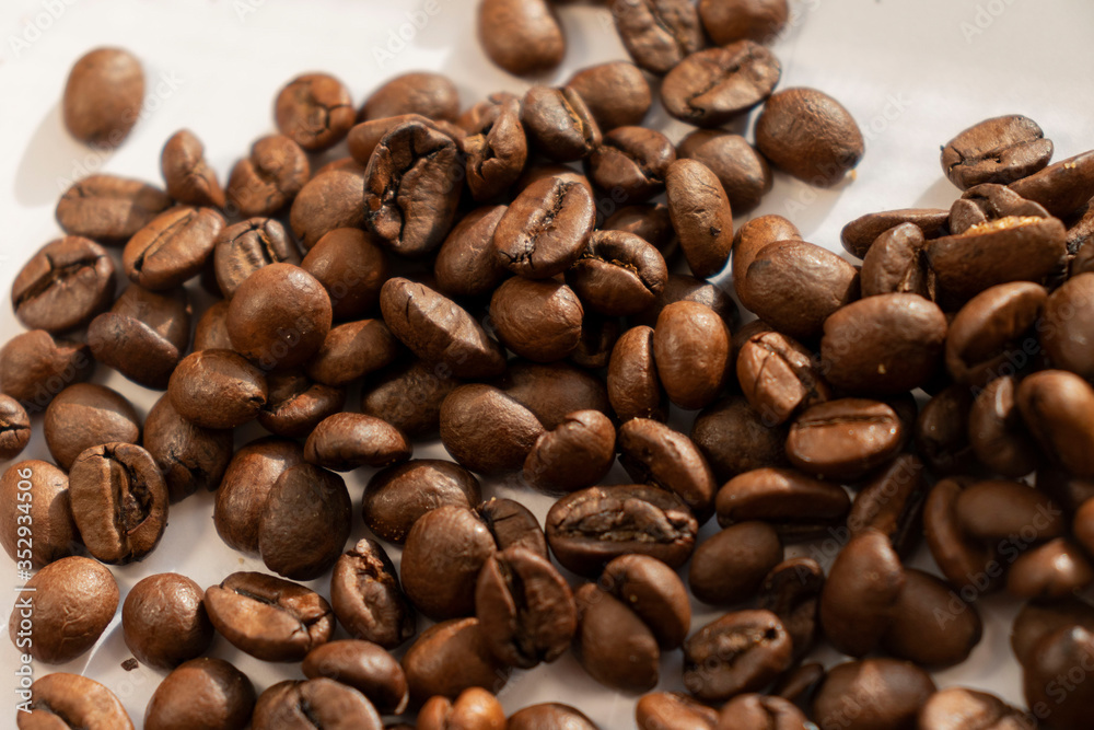 coffee beans a lot of coffee scattered on a white background coffee beans a lot of coffee scattered on a white background