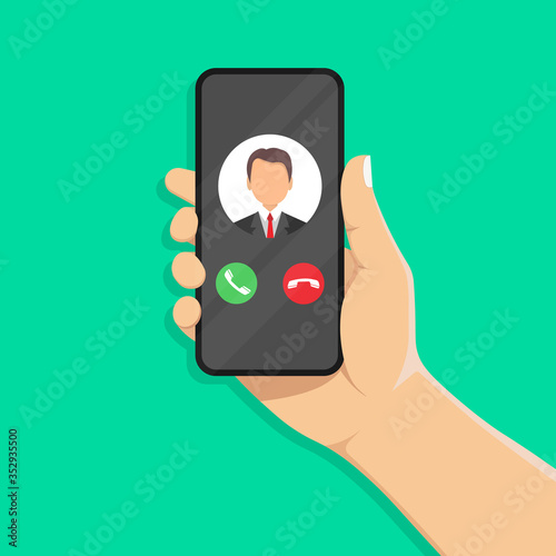 Incoming call on the smartphone screen with the image of the caller. Phone in a human hand.