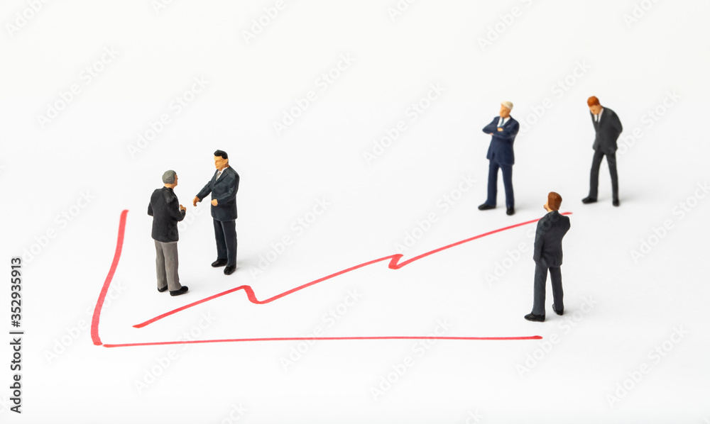 Miniature people on paper with painted financial chart.