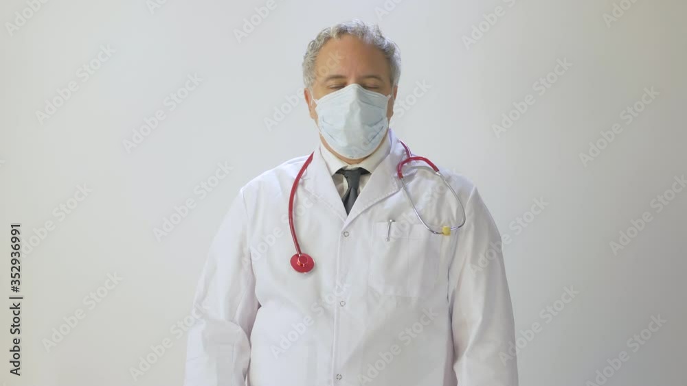 Portrait of Medical Doctor With Protective Mask and protective gloves doing thumbs up sign with finger concept of heatlh fight against coronavirus COVID 19 in Quarantine Pandemic Outbreak Lockdown Portrait of Medical Doctor With Protective Mask and protective gloves doing thumbs up sign with finger concept of heatlh fight against coronavirus COVID 19 in Quarantine Pandemic Outbreak Lockdown