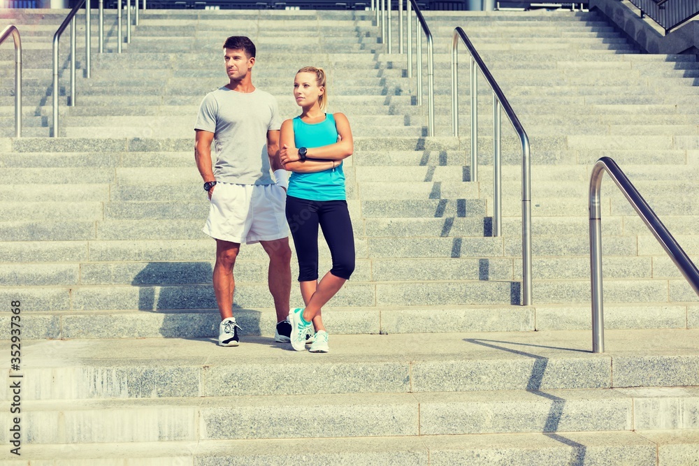 Fototapeta premium Young attractive couple standing in stairs 