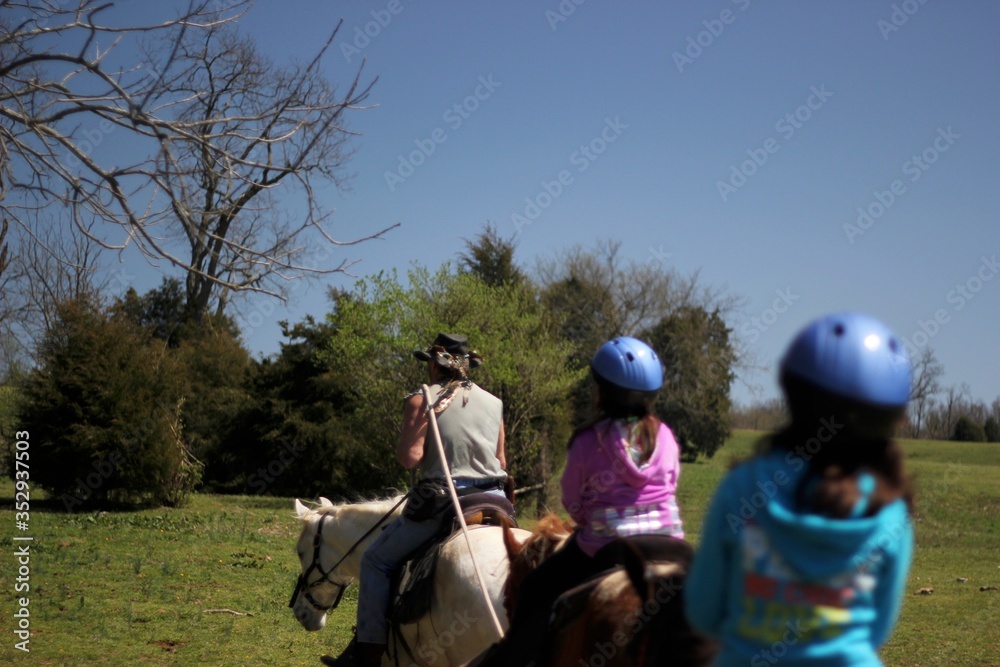 Horse riding guide is leading group of children Horse riding guide is leading group of children