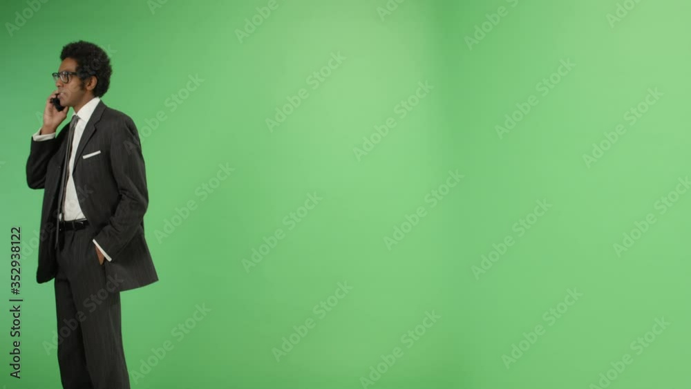 Businessman walking and talking on phone with green screen Businessman walking and talking on phone with green screen