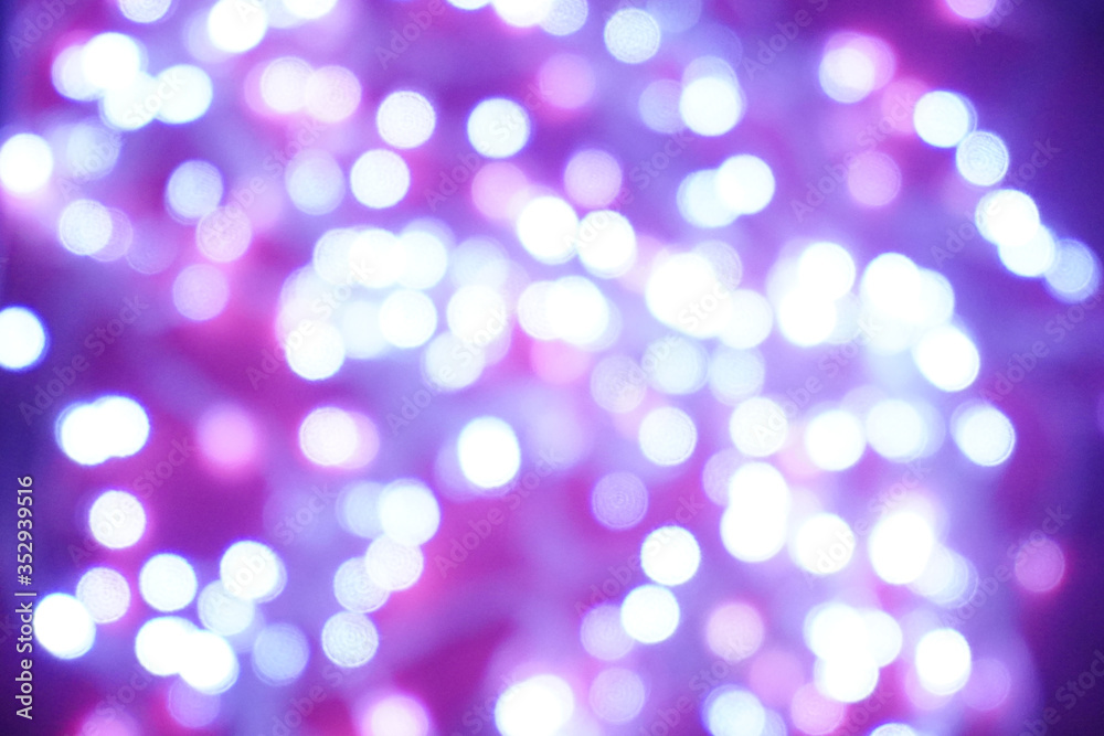 Fototapeta premium Blue lights on a purple background are blurred. Concept of blank frame,copy space. Christmas or new year flatlay background.