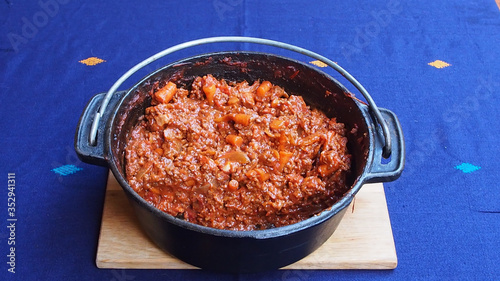 Cooked bolognaise mince in a cast iron pot or dutch oven