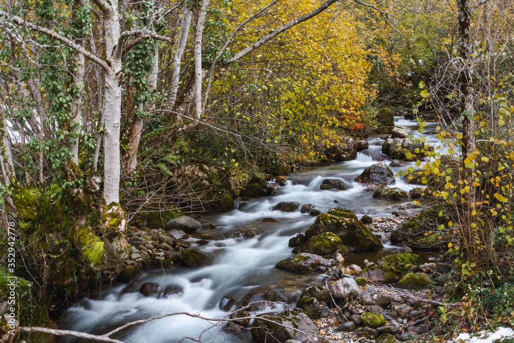The river in autumn with the water flowing down The river in autumn with the water flowing down