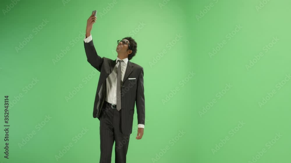 Businessman finding phone signal on green screen Businessman finding phone signal on green screen