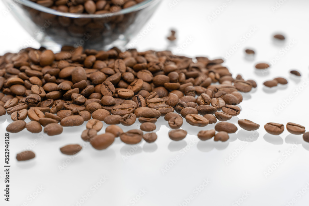 scattering of coffee beans on a glossy bright table with reflection. scattering of coffee beans on a glossy bright table with reflection.