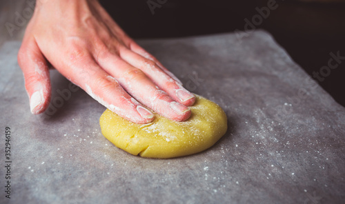 Woman makes dough from flour for baking. photo