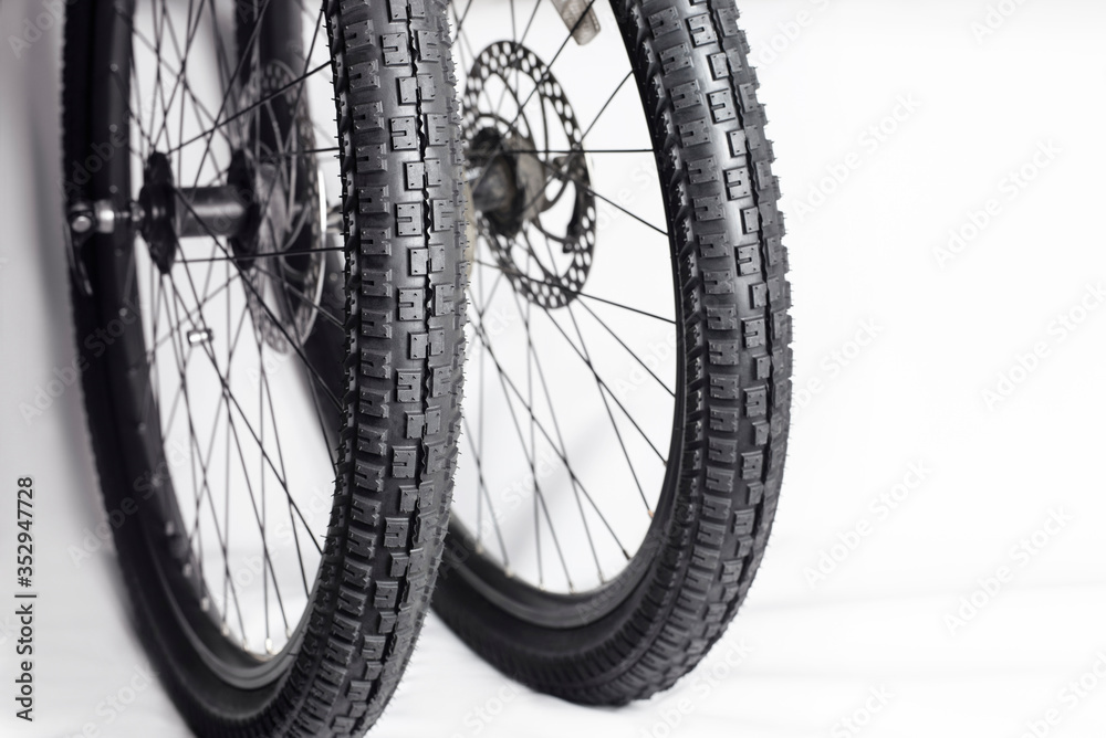 New bicycle tires on wheels from a mountain bike, close up New bicycle tires on wheels from a mountain bike, close up