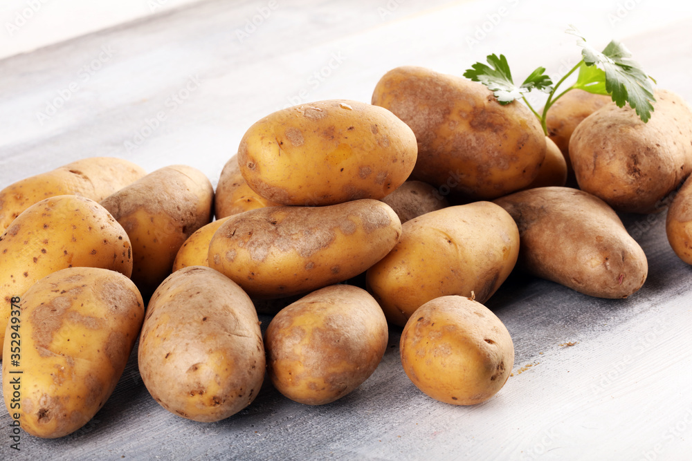 Pile of potatoes lying on wooden boards. Fresh healthy potato Pile of potatoes lying on wooden boards. Fresh healthy potato