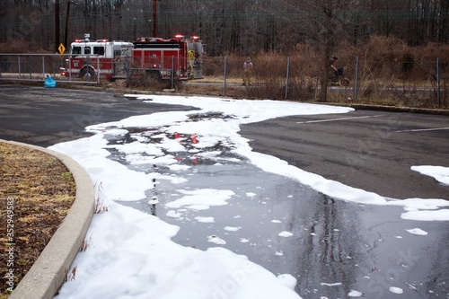 Firefighting foam remains on the ground surface following a tanker truck accident. 