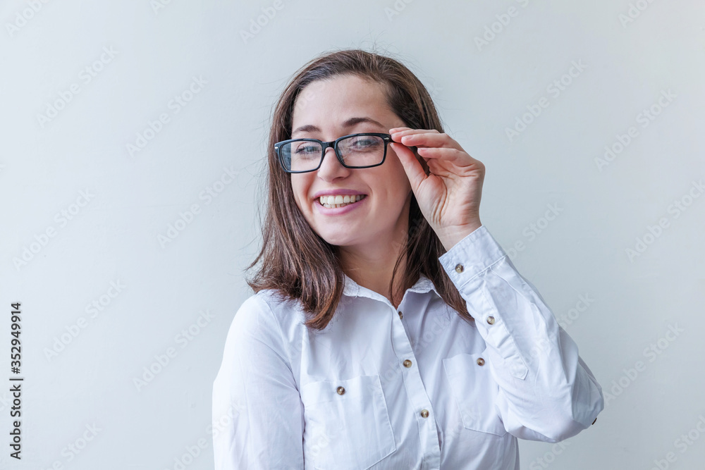Beautiful happy girl smiling. Beauty simple portrait young smiling brunette woman in eyeglasses isolated on white background. Positive human emotion facial expression body language. Copy space Beautiful happy girl smiling. Beauty simple portrait young smiling brunette woman in eyeglasses isolated on white background. Positive human emotion facial expression body language. Copy space