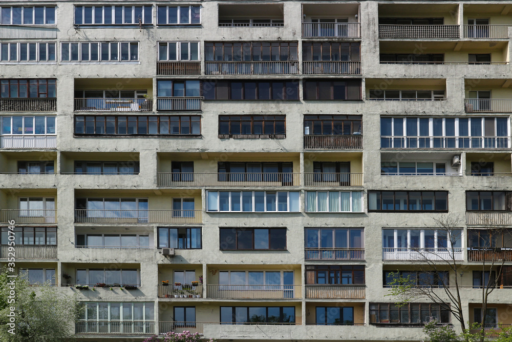 Balconies and windows of a multi-storey apartment building. Old Soviet high-rise building with balconies. City background.