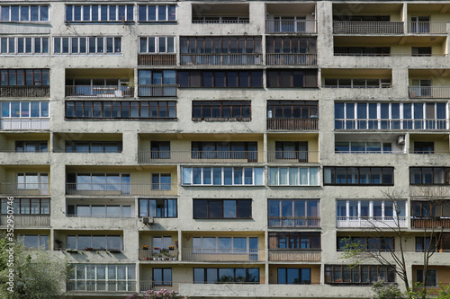 Balconies and windows of a multi-storey apartment building. Old Soviet high-rise building with balconies. City background.