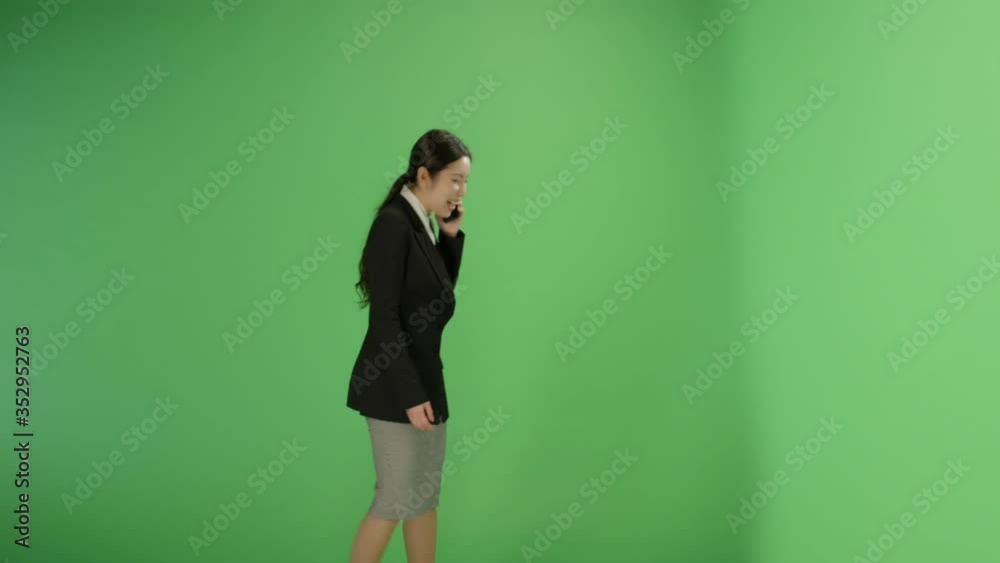 Happy Woman Walking and Talking on Phone