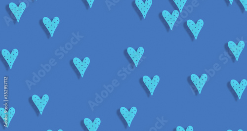 abstract Seamless light cyan blue hearts shape on texture blue background.