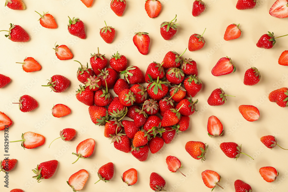 Heart made of tasty strawberry on beige background, top view. Summer berry Heart made of tasty strawberry on beige background, top view. Summer berry