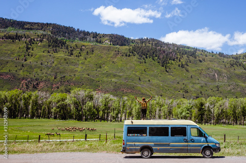 Woman standing on a camper van