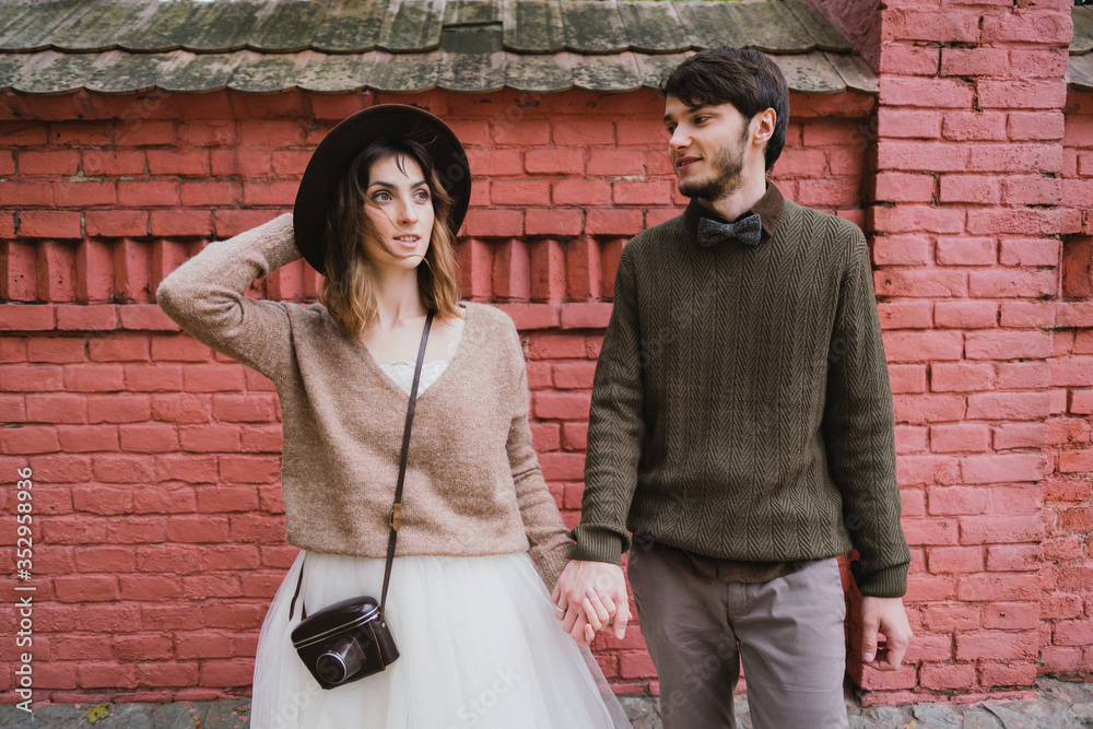 Romantic and happy caucasian couple in casual wedding clothes walking and hugging at the city streets. Love, relationships, romance, happiness, urban concept. Man and woman celebrate their marriage. Romantic and happy caucasian couple in casual wedding clothes walking and hugging at the city streets. Love, relationships, romance, happiness, urban concept. Man and woman celebrate their marriage.