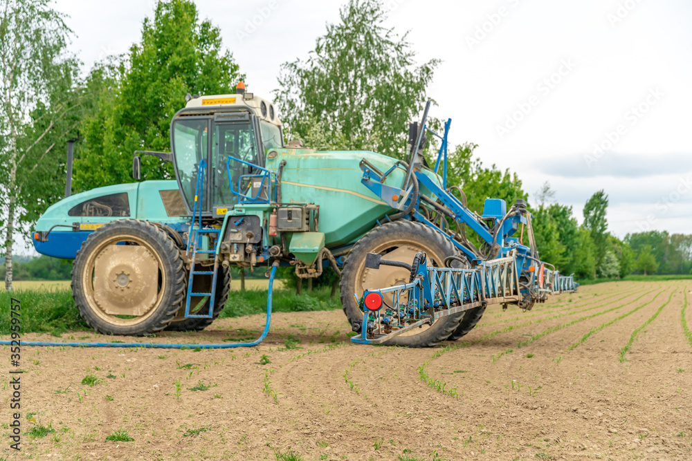 tractor adapted for spraying weeds and pests in field tractor adapted for spraying weeds and pests in field