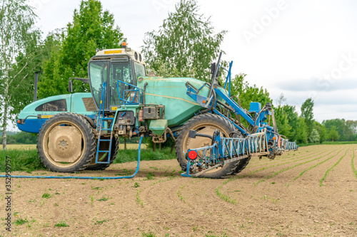 tractor adapted for spraying weeds and pests in field