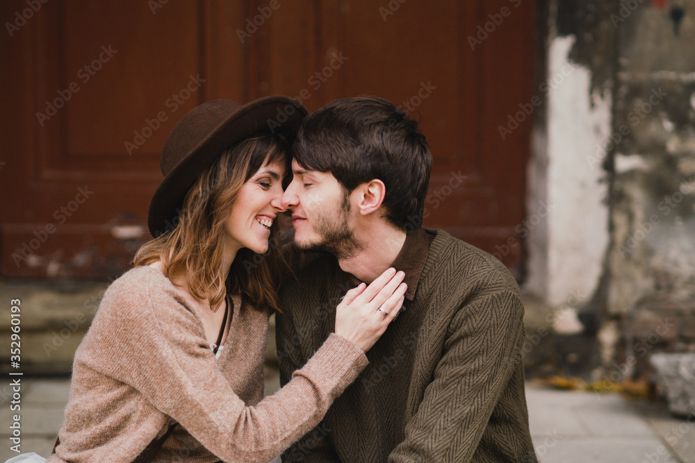 Romantic and happy caucasian couple in casual wedding clothes walking and hugging at the city streets. Love, relationships, romance, happiness, urban concept. Man and woman celebrate their marriage.