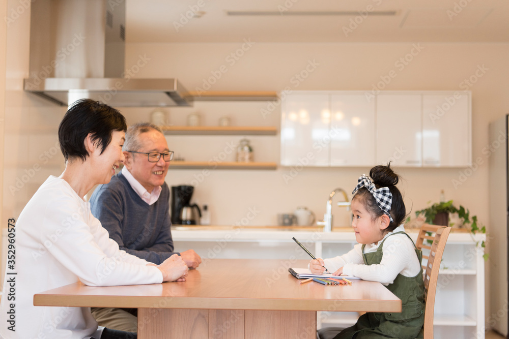 Grandparents looking at grandchild drawing