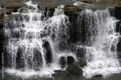 Water cascading over multiple rock ledges.